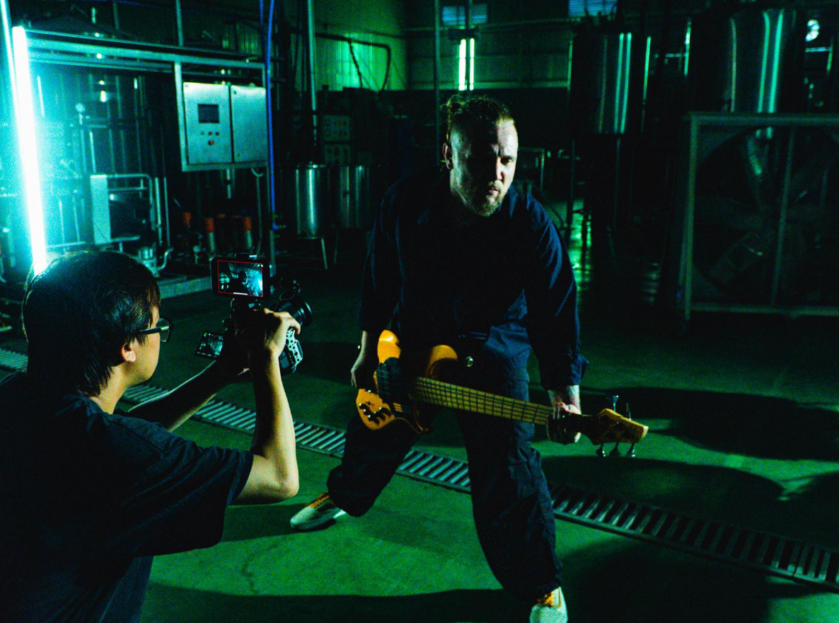 Bassist with photographer in green lighting